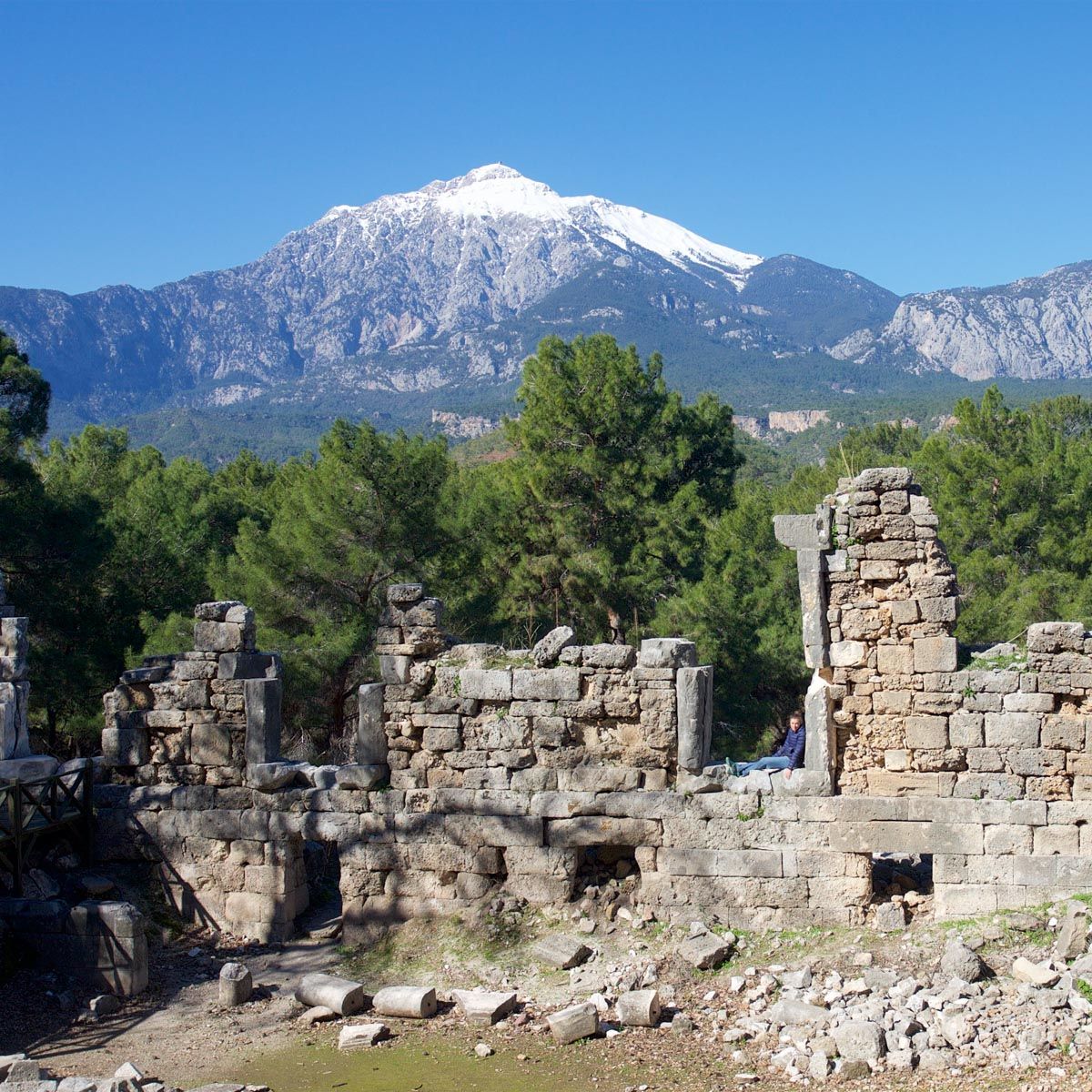The walls of an ancient theatre with the backdrop of snowy mountain  in Phaselis 