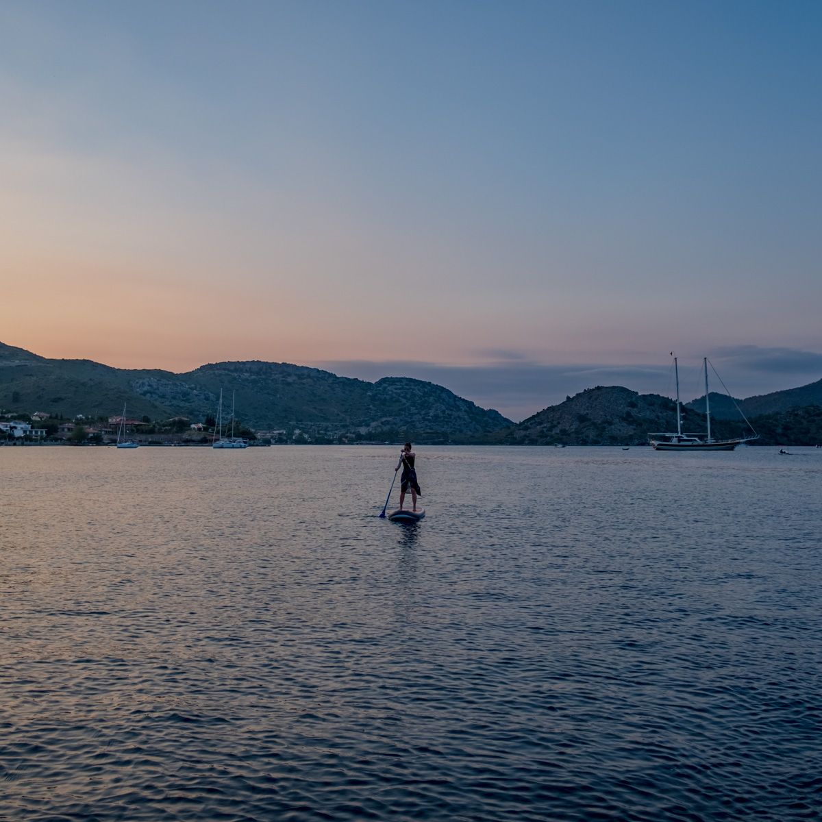 solo paddleboarder in Selimiye at sunset 
