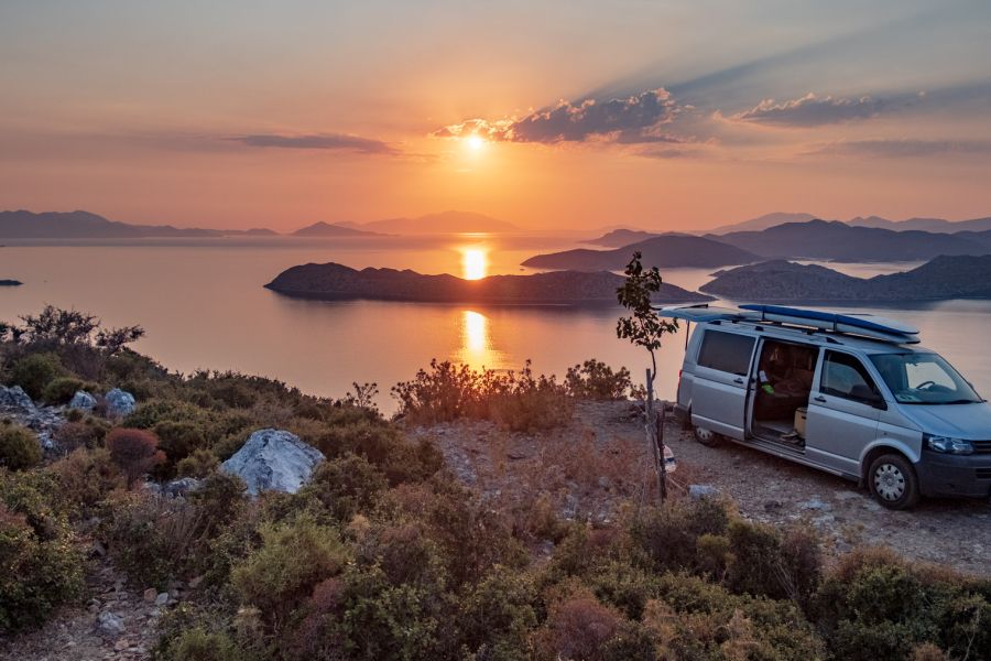 camper on a high point overlooking a sunset